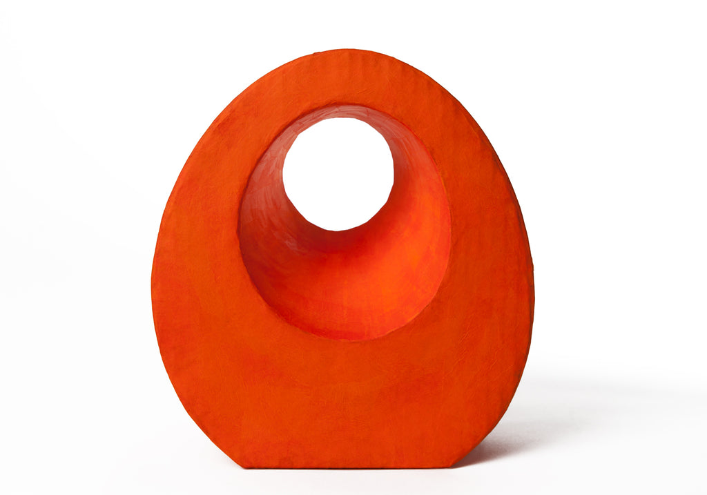 Picture of a beautiful orange tear drop shaped biodegradable paper cremation urn on sale at Muses Design Urns. Front view.