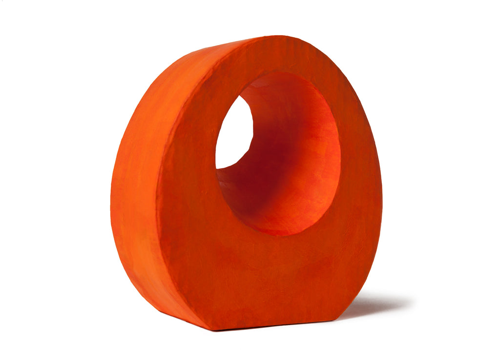 Picture of a beautiful orange tear drop shaped biodegradable paper cremation urn on sale at Muses Design Urns. Left side view.