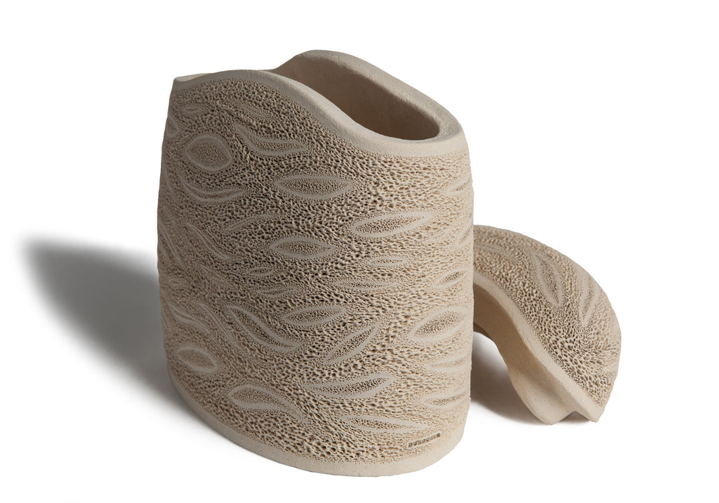 Picture of a beige ceramics (faience) monolith shaped cremation urn on sale at Muses Design Urns. Left side view.